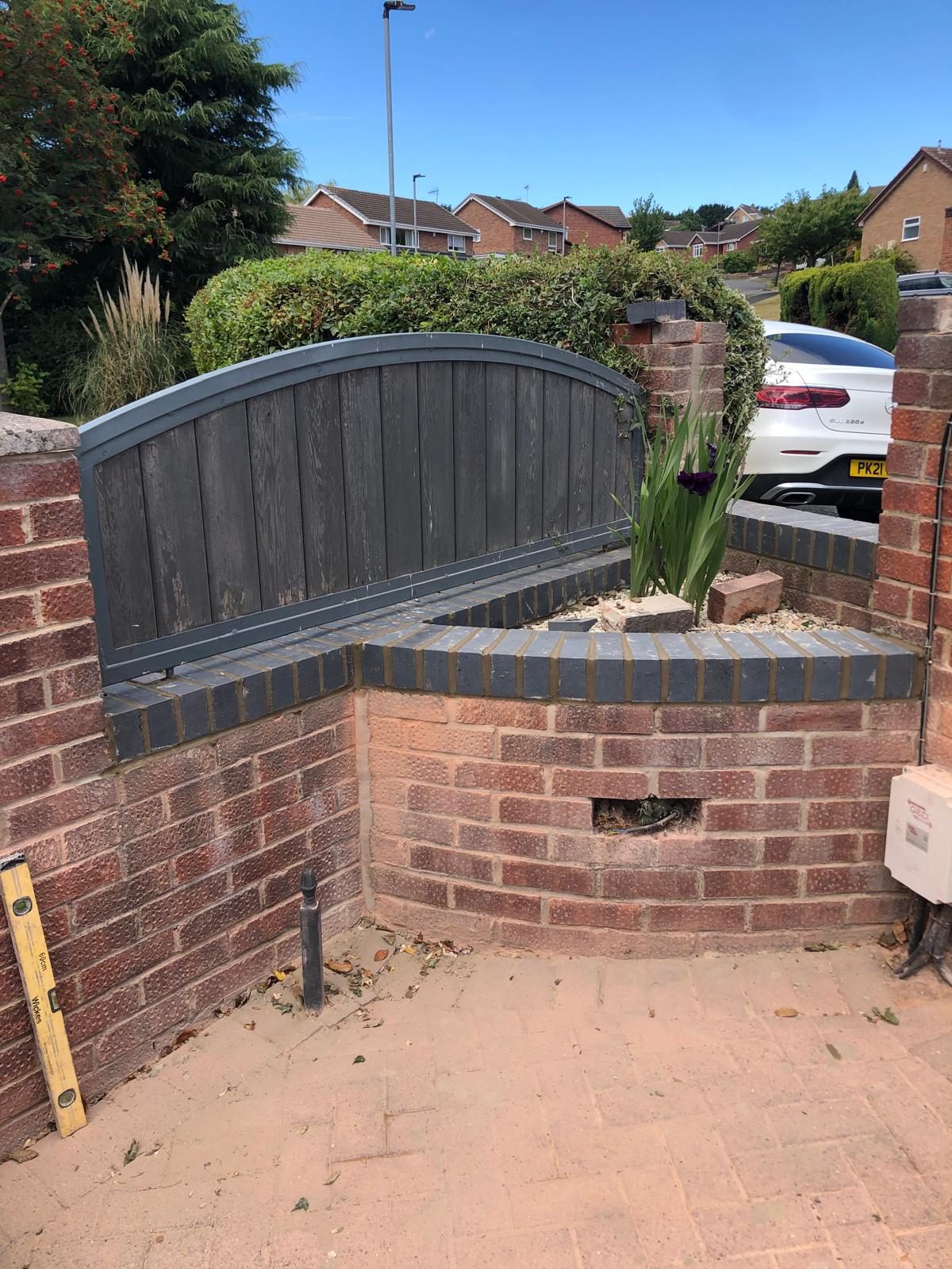 Garden wall and gate with brick edging