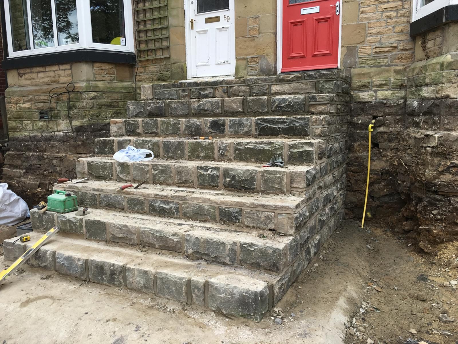 Stone steps under construction outside a house